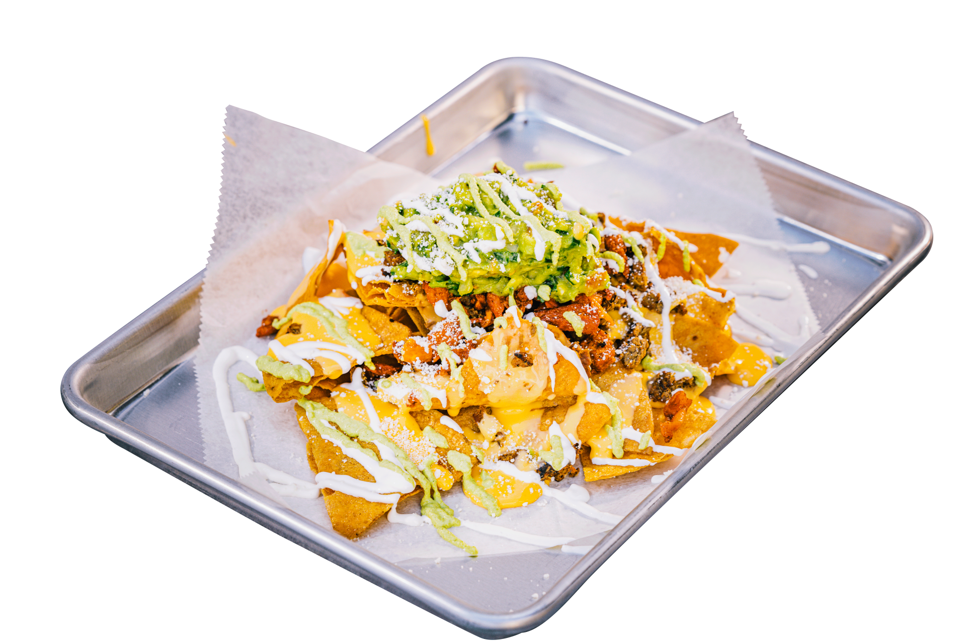 A tray of nachos with sauce and lettuce on a white background.