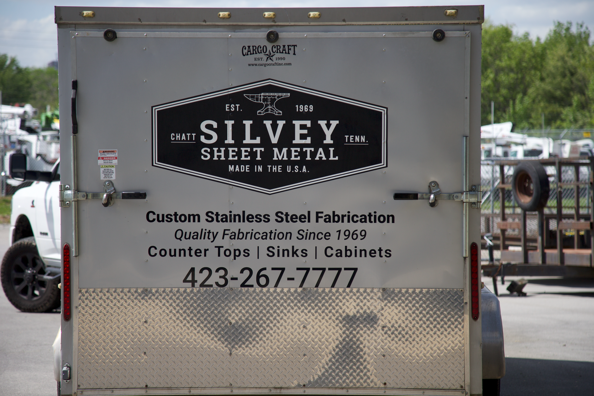 A silver trailer that says silvey sheet metal on it