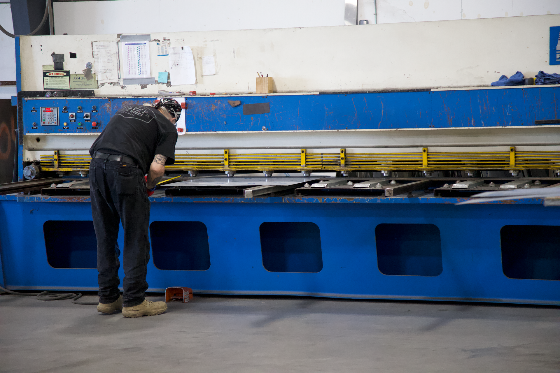 A man is working on a machine in a factory.