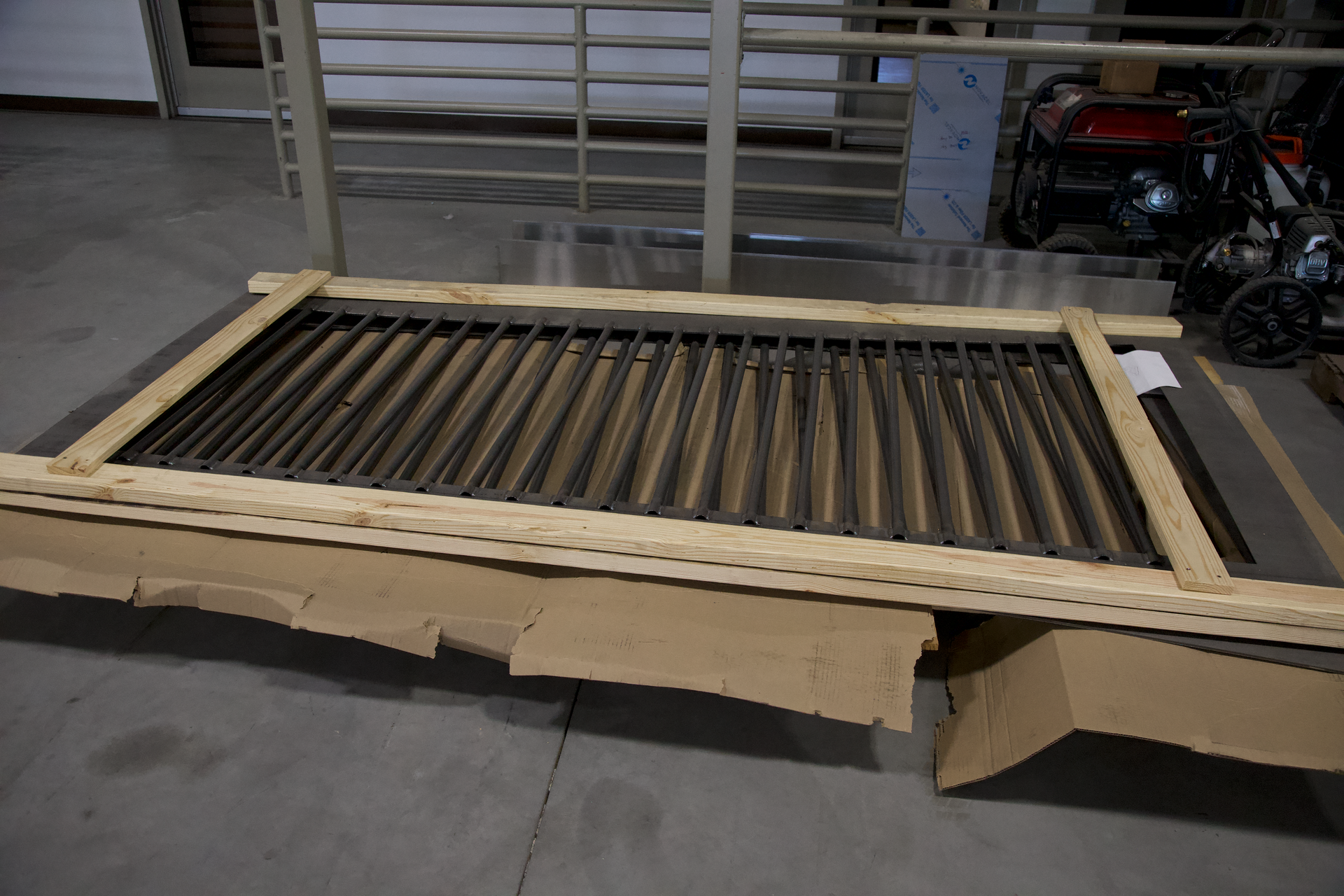 A piece of metal is sitting on top of a cardboard box.