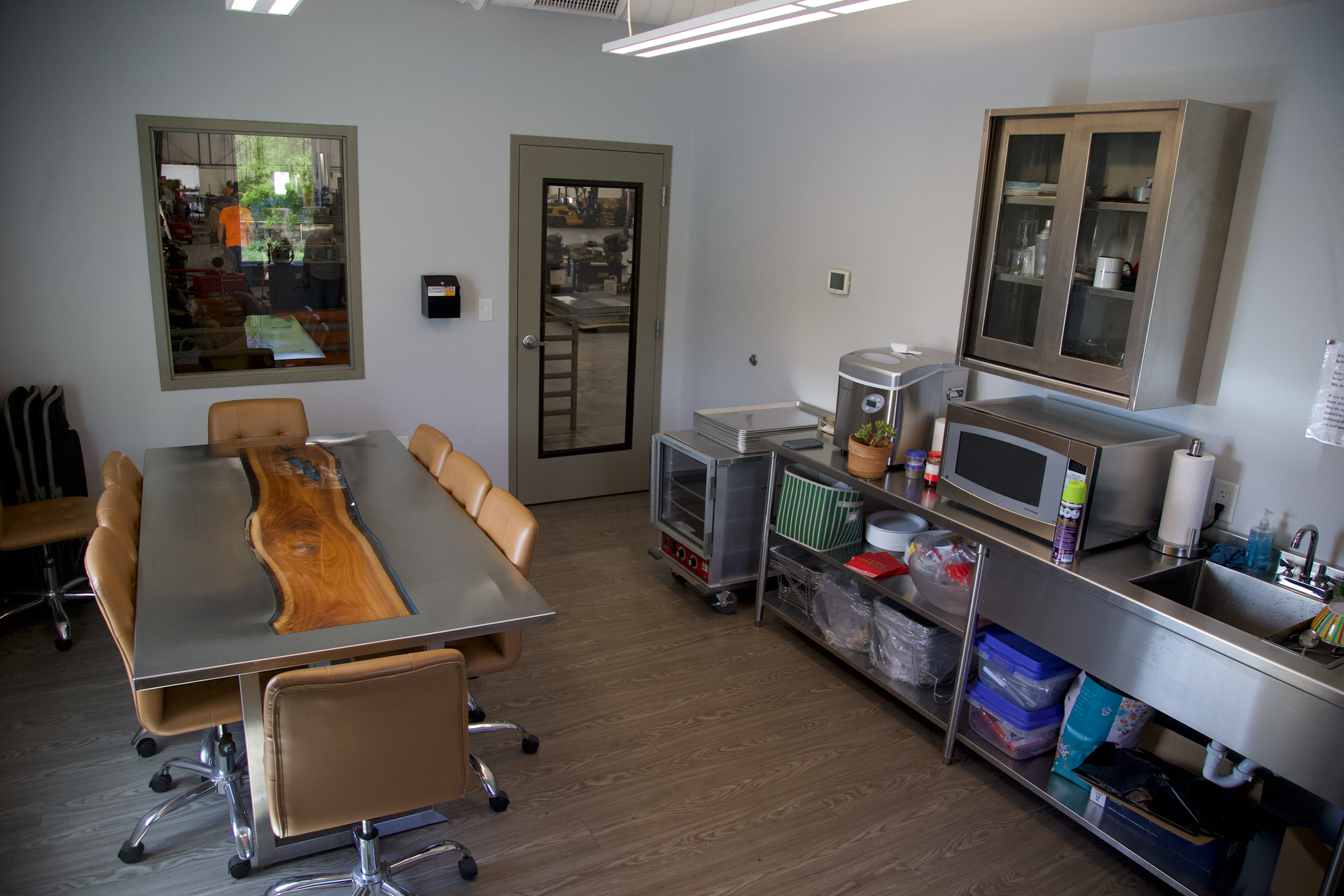 A kitchen with a table and chairs and a sink.