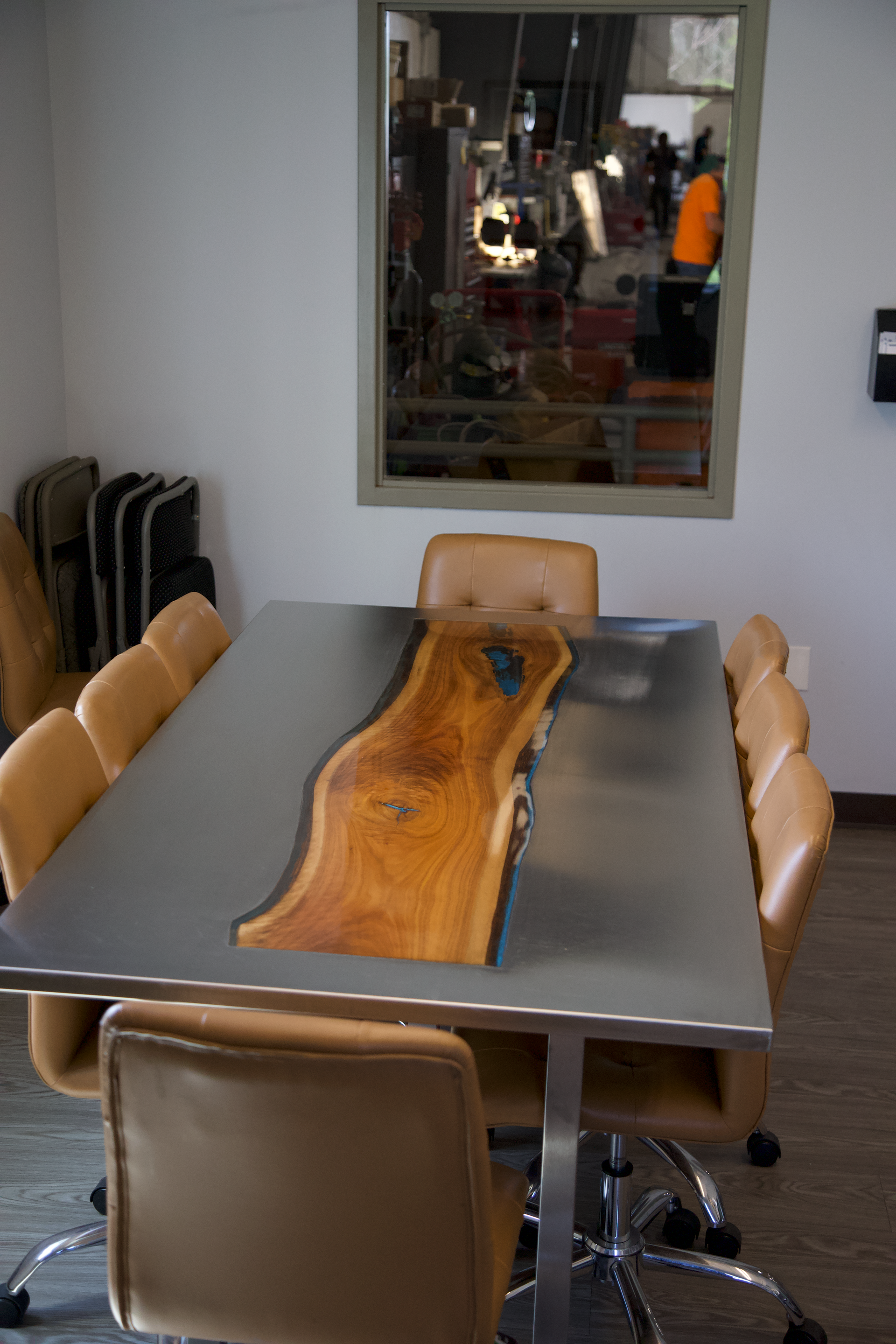 A conference room with a wooden table and chairs.