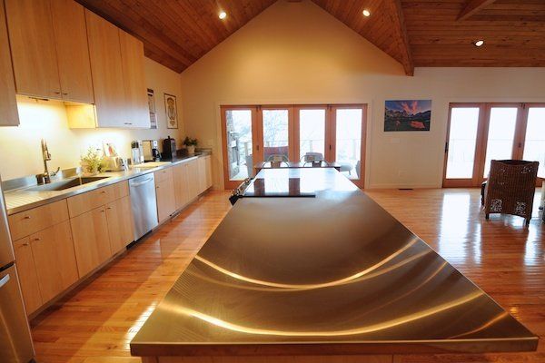 A kitchen with a large stainless steel counter top