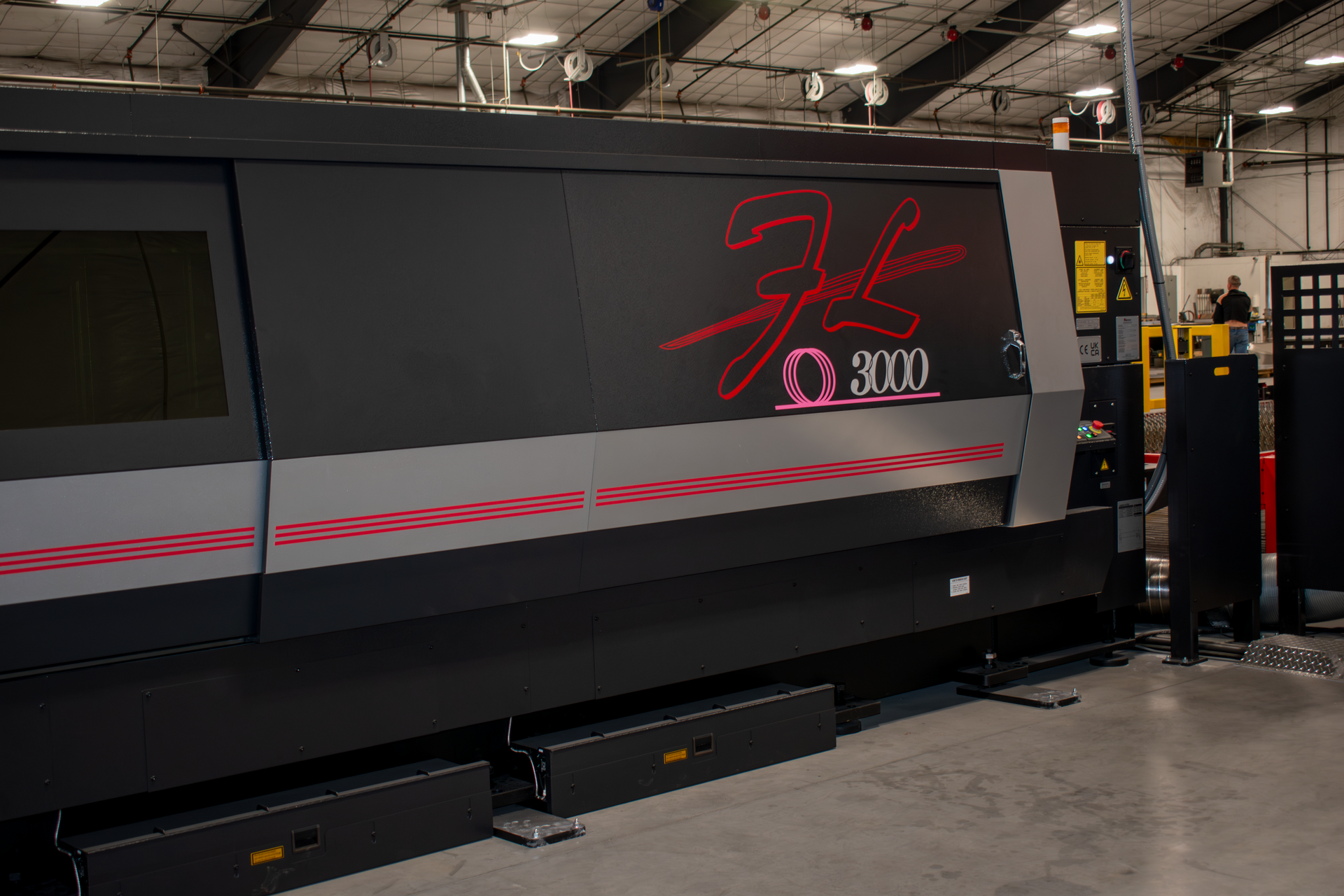 Laser cutter in action, cutting metal with bright sparks.