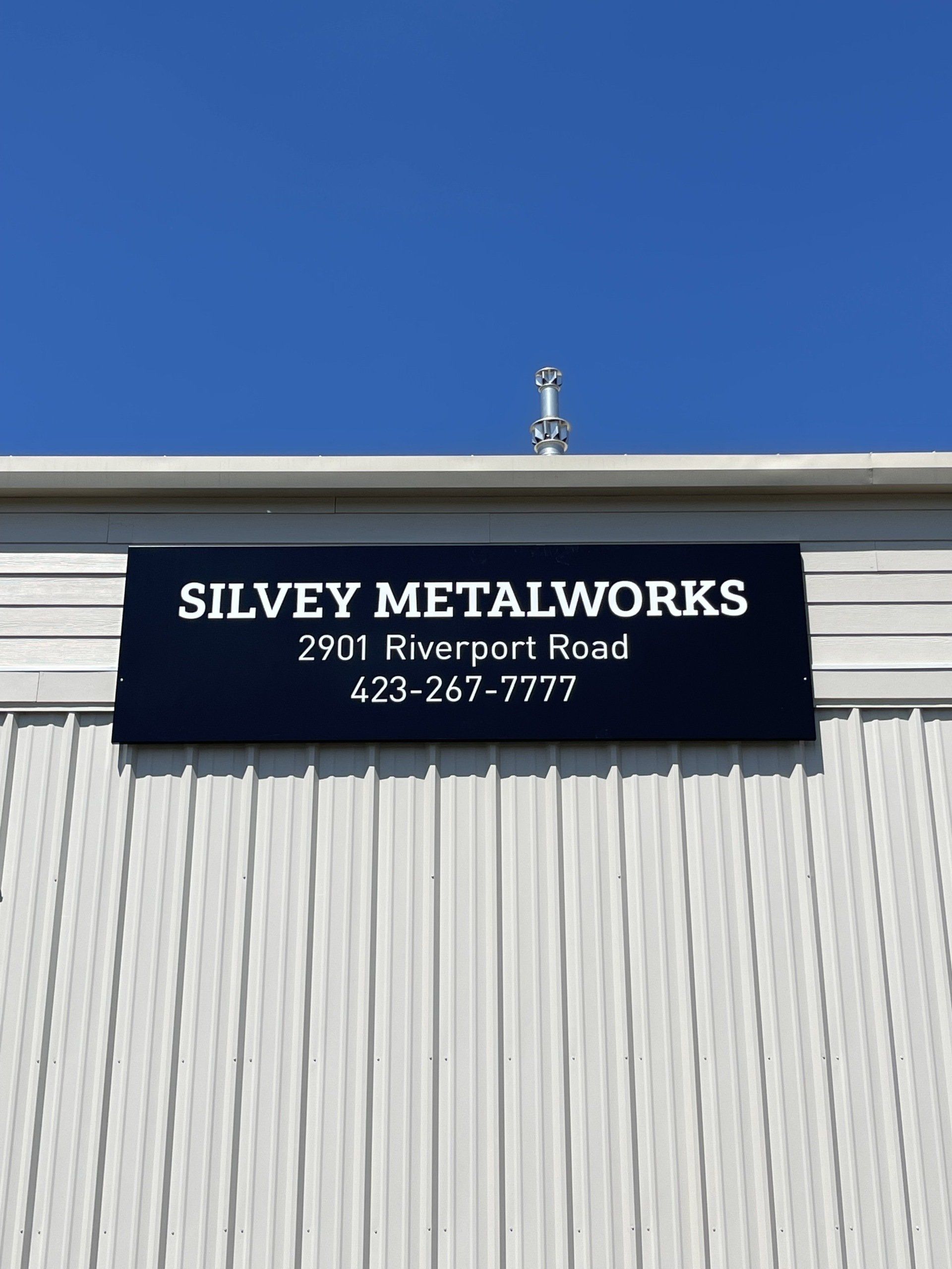A sign on the side of a building that says silvey metalworks