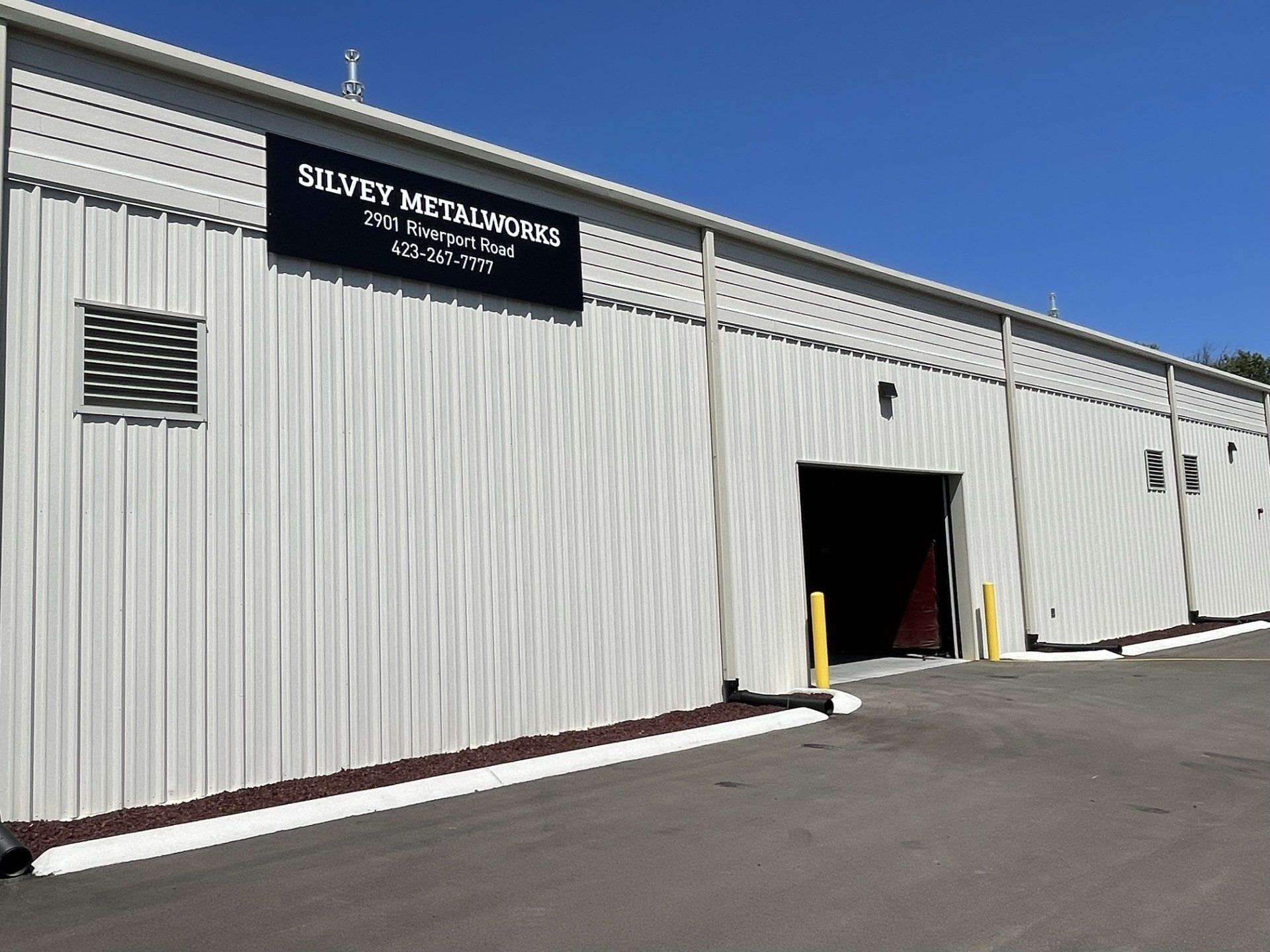 A large white building with a black sign that says silvery media center