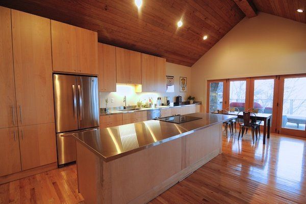A kitchen with stainless steel appliances and wooden cabinets