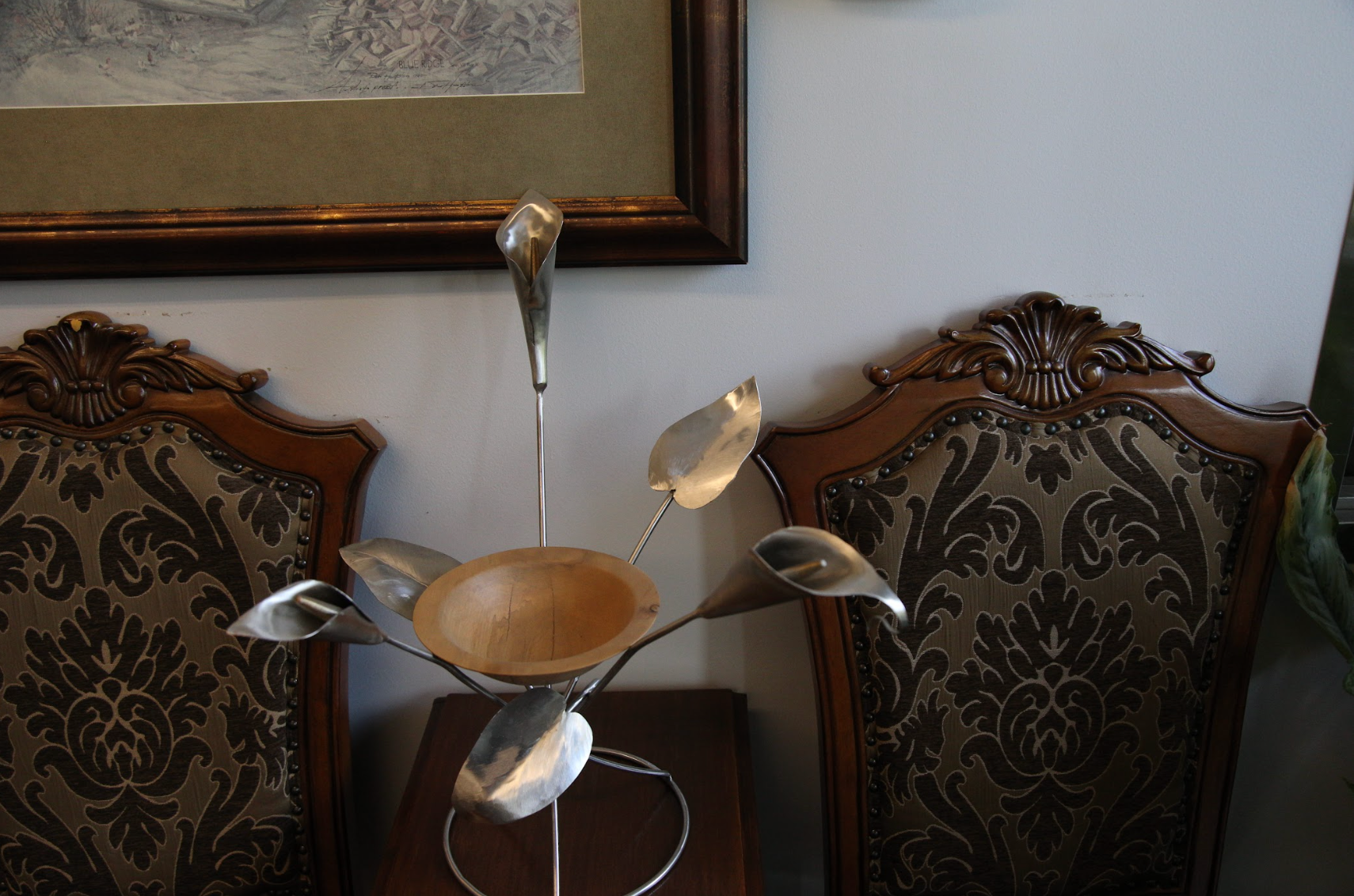 A table with a bowl and spoons on it