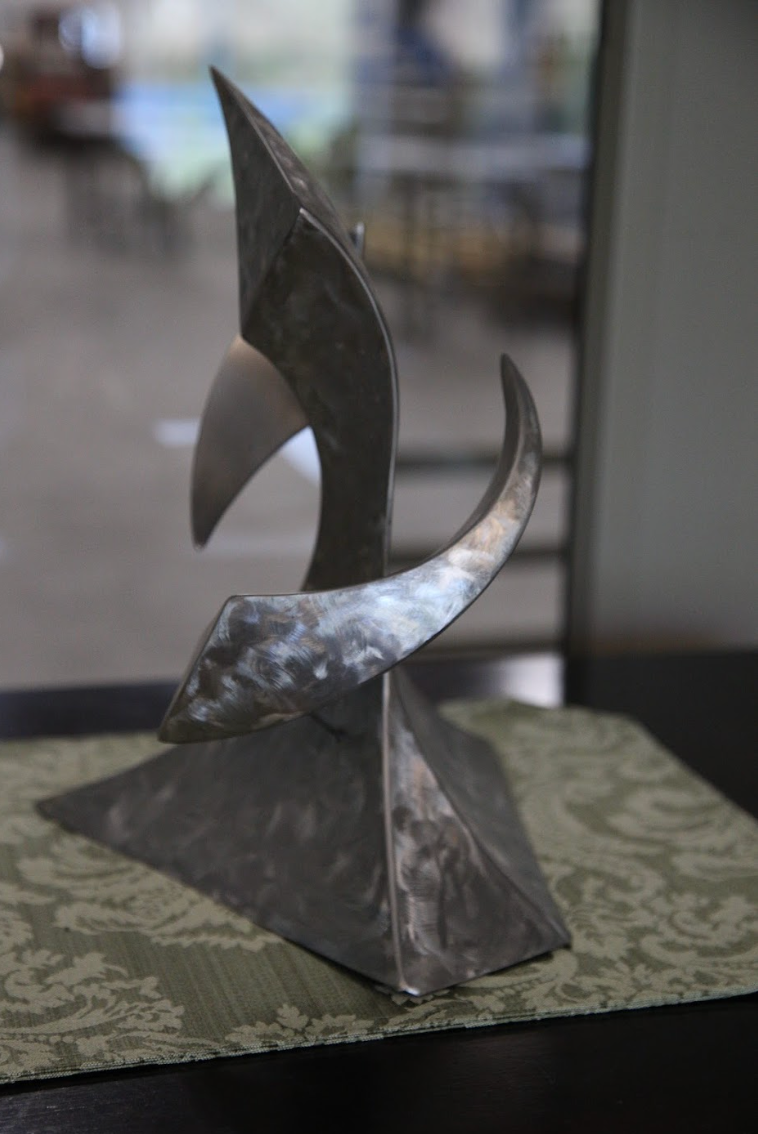 A statue of a bird is sitting on a table.