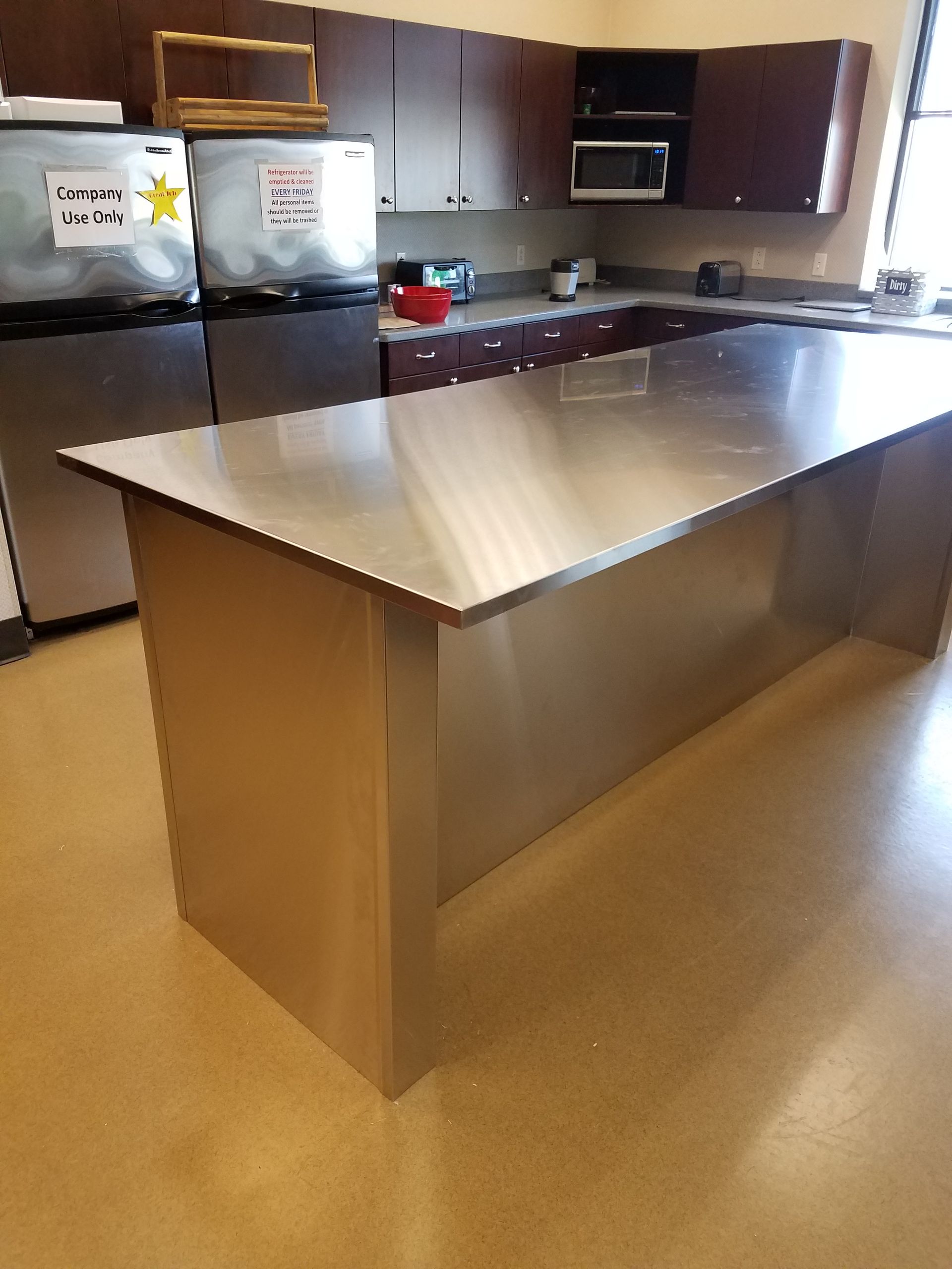 A kitchen with a large stainless steel counter top
