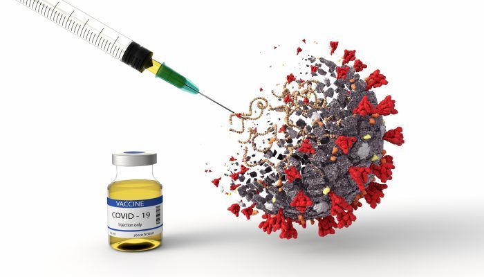 Coronavirus being injected with syringe, with vaccine bottle next  to it.