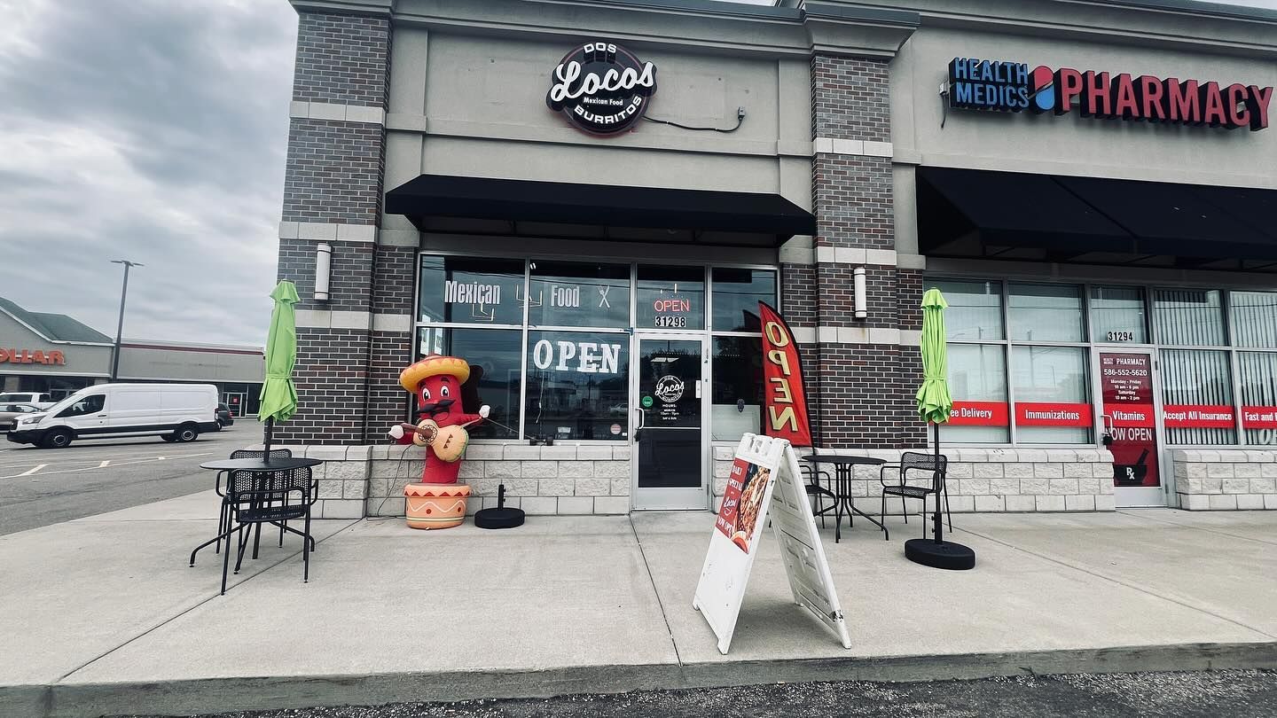 A restaurant with a sign in front of it that says `` open ''.