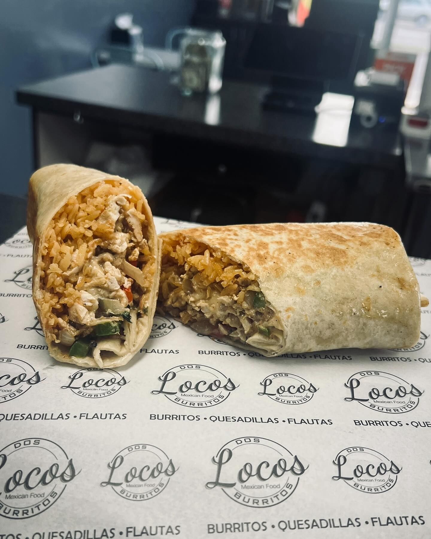 Two burritos are sitting on a piece of paper that says locos