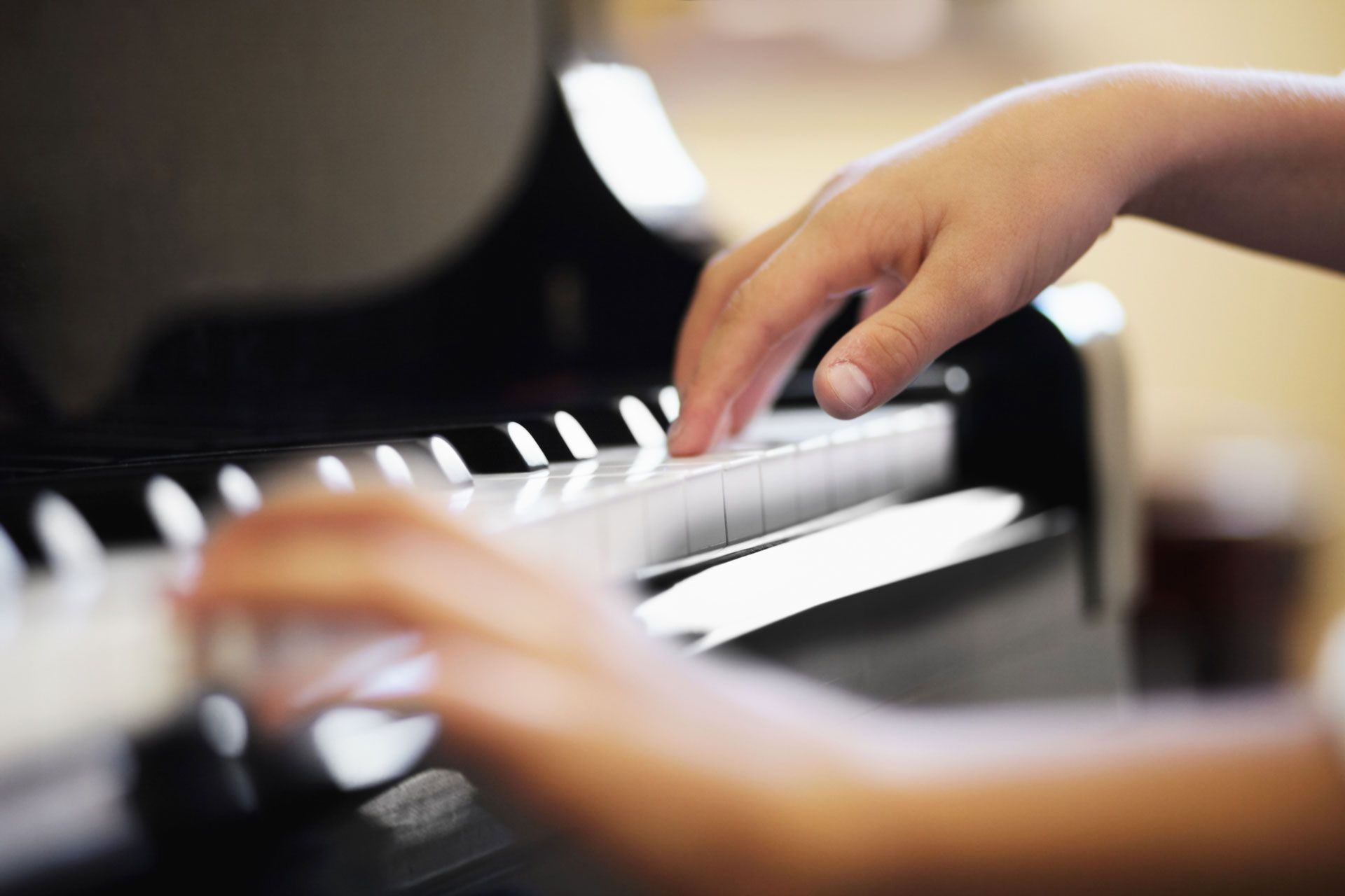 A close up of a person playing a piano
