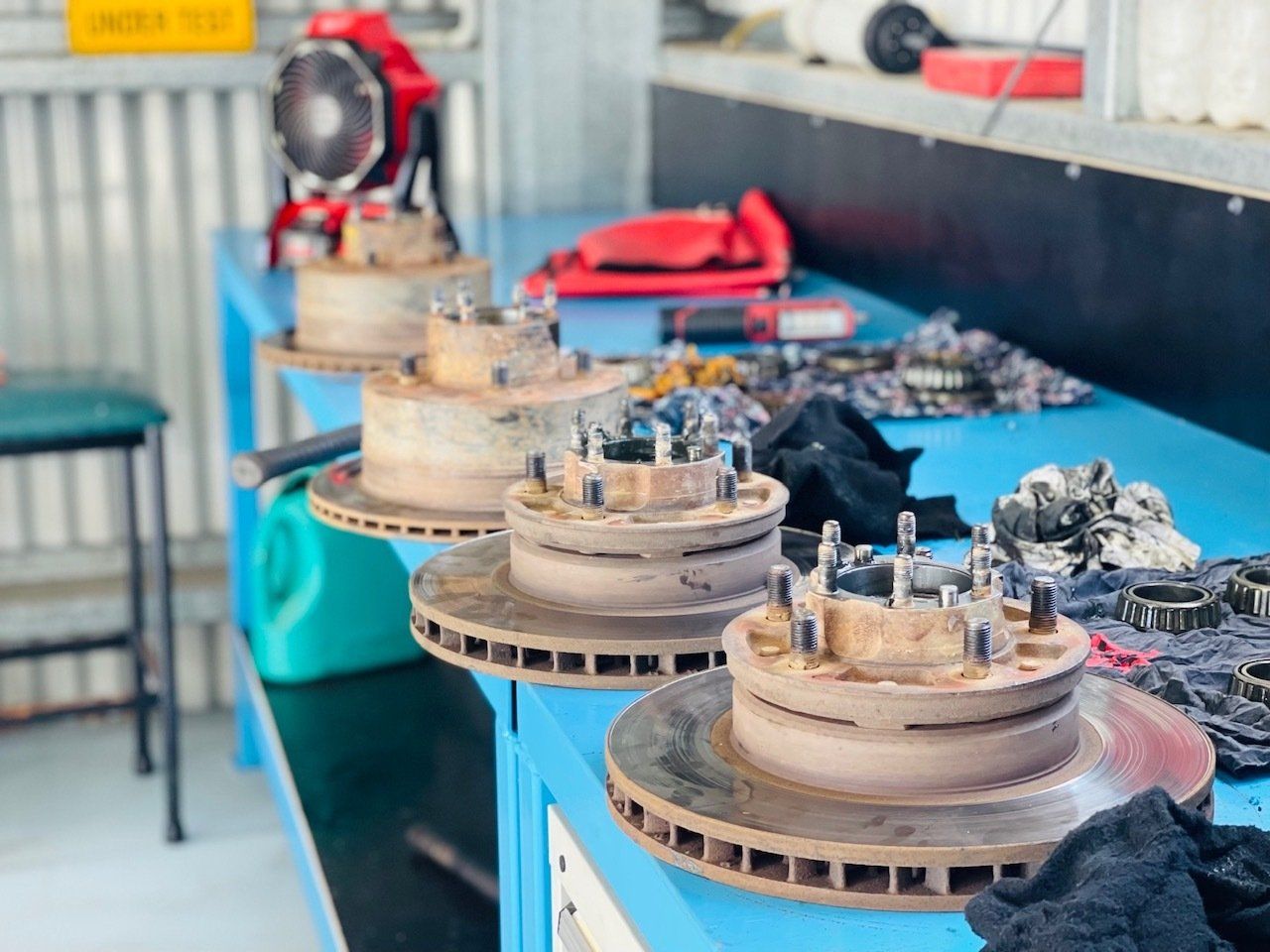 A Row Of Brake Rotors Sitting On Top Of A Blue Table — Aspire Diesel In Gracemere, QLD