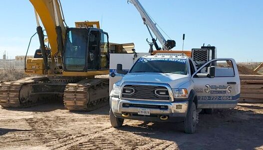 A white truck is parked next to a yellow excavator on a dirt road.