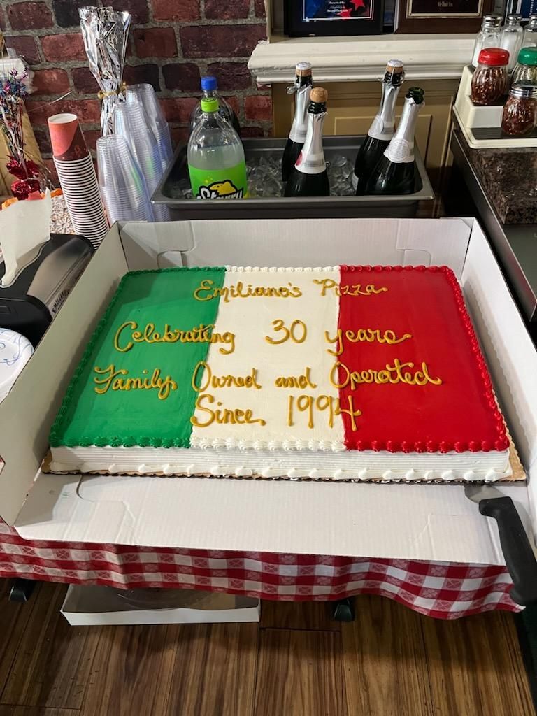 A large cake is sitting in a box on a table.