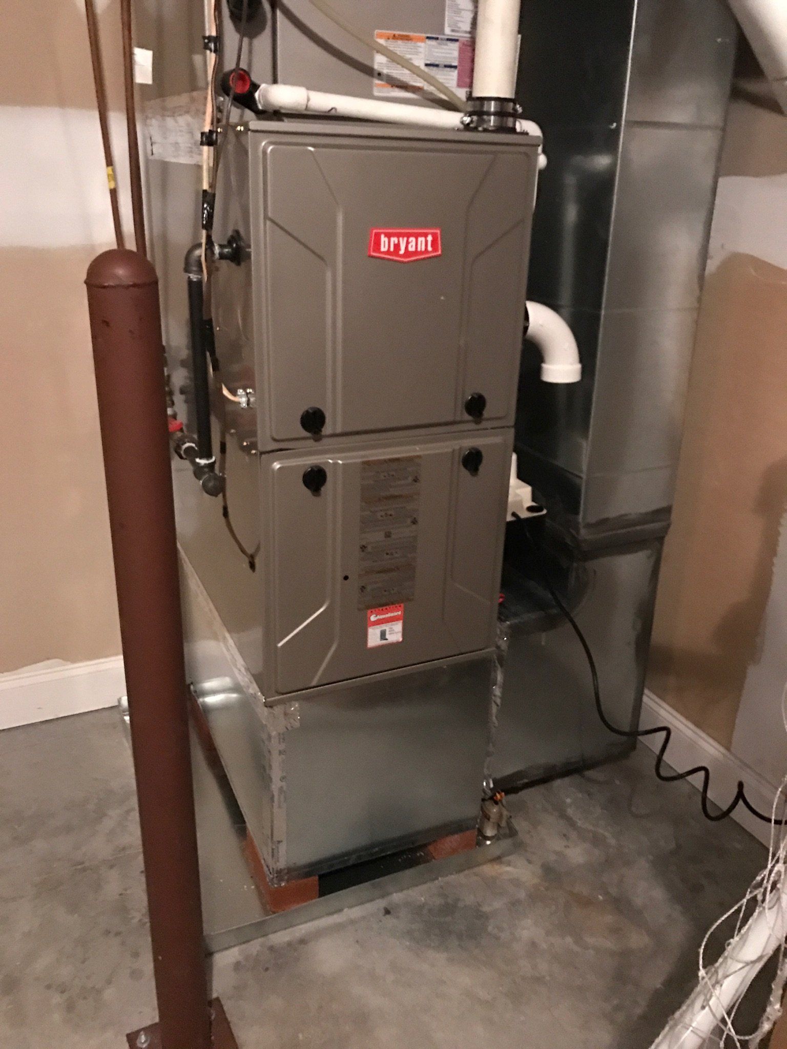 A recently installed bryant heater in a basement
