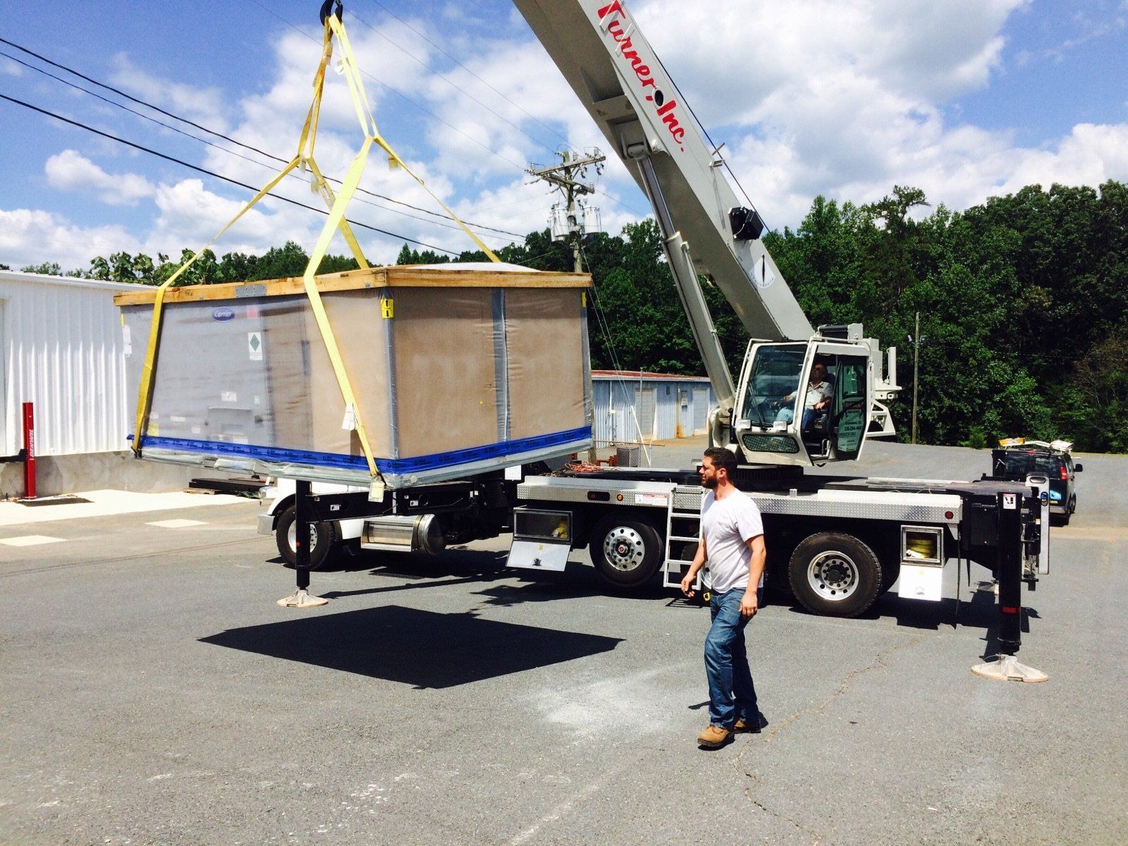 HVAC equipment being transported by crane.