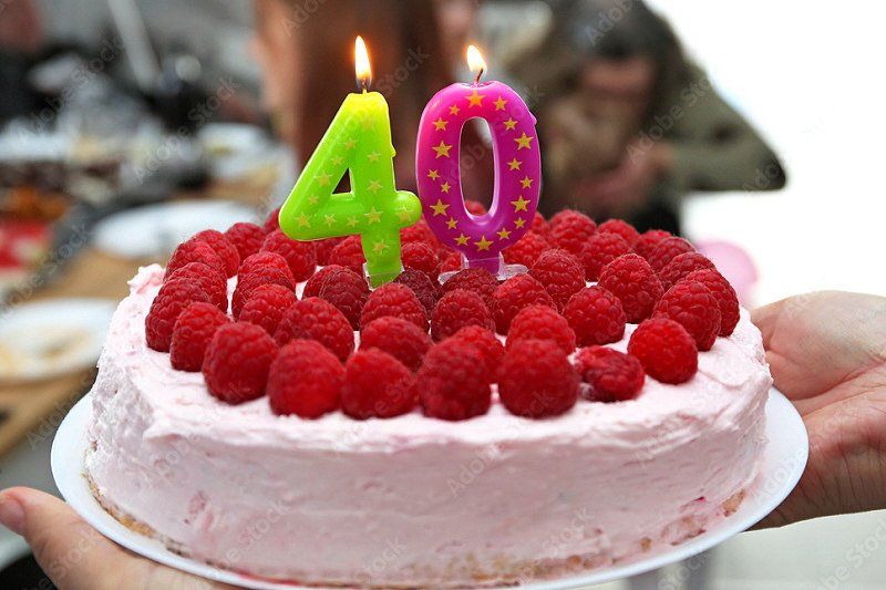 Adult Social Event 40th birthday cake with white frosting and raspberries on top
