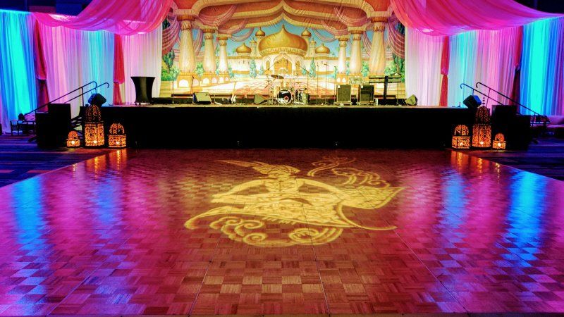 Galas and fundraising event Arabian nights with Aladdin character floor and stage arrangement