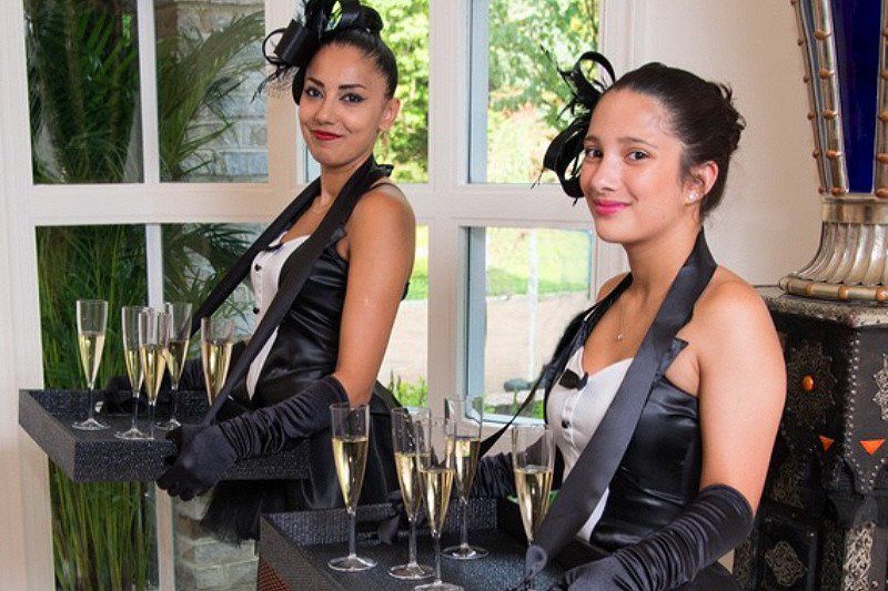 Adult Social Event Casablanca theme party greeters in period costumes with champagne