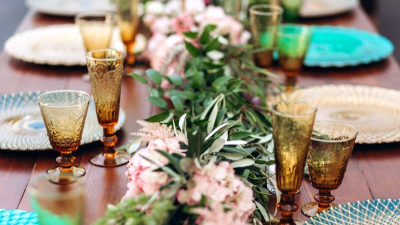 Casual elegance party table setting with floral arrangement