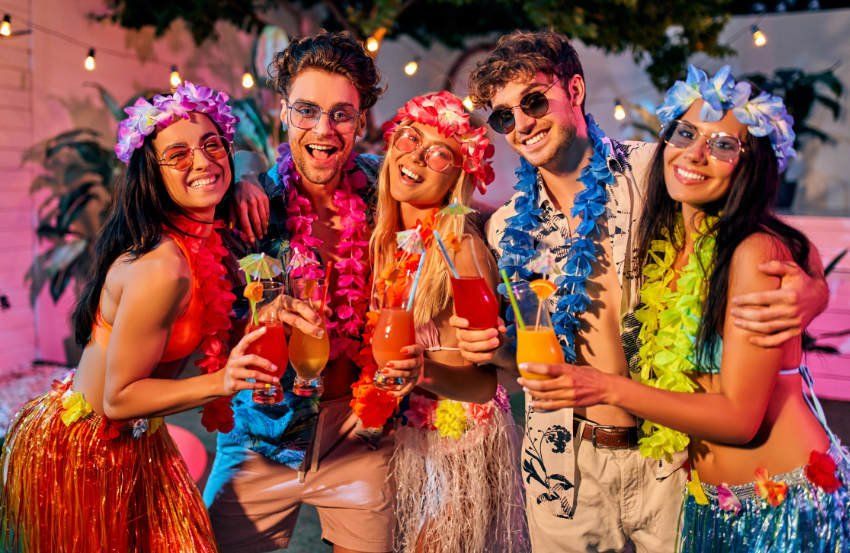 Group having fun dressed in Hawaiian Polynesian Luau styled clothes