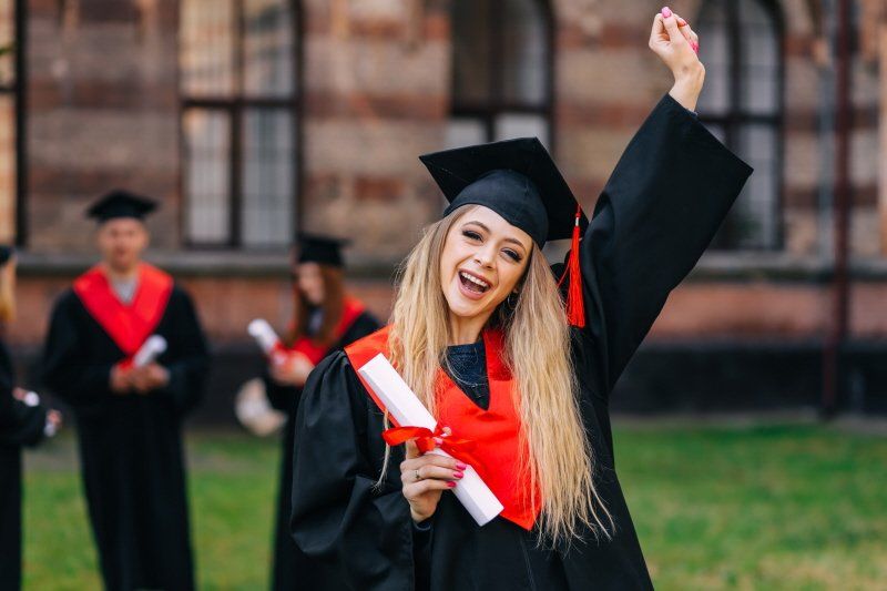 Student events graduation setting with female graduate raising hand