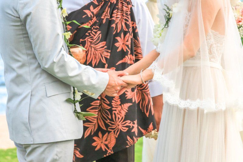 Wedding celebration Hawaiian styled ceremony with clothing and couple holding hands