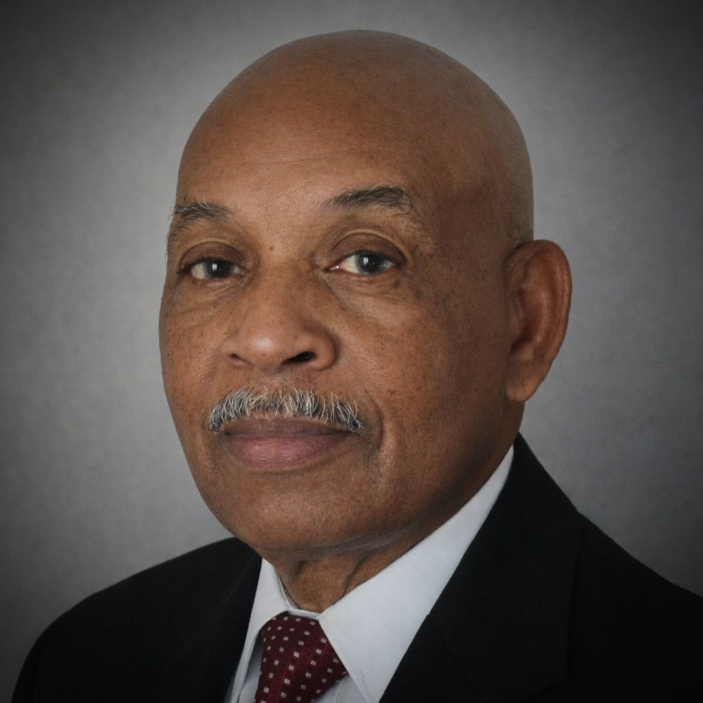 Woman with dark wavy hair smiling, wearing a red top, outdoors.