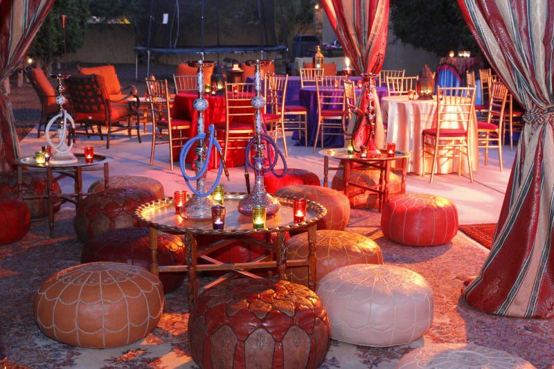 Seating and tables image showing Moroccan leather poufs, brass tray, and table setup