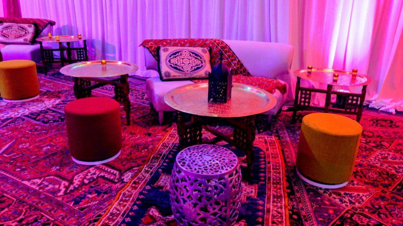 Galas and fundraising event Moroccan themed sitting area with stools and tables