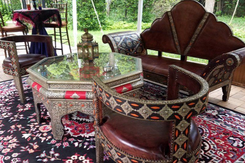 Adult Social Event Moroccan themed table setup with matching rug in outdoor tent