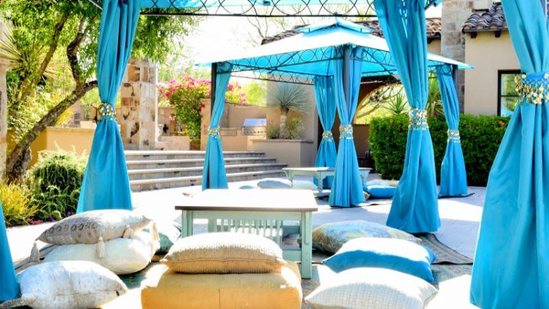 Poolside party tent with table and pillows