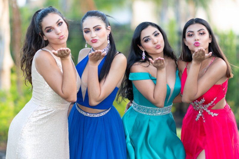 Student events showing four colorfully dressed women posing for the camera
