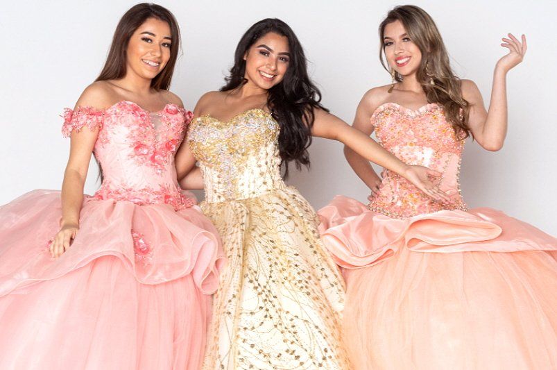 Teen birthday party showing three women dressed in Quinceanera styled outfits