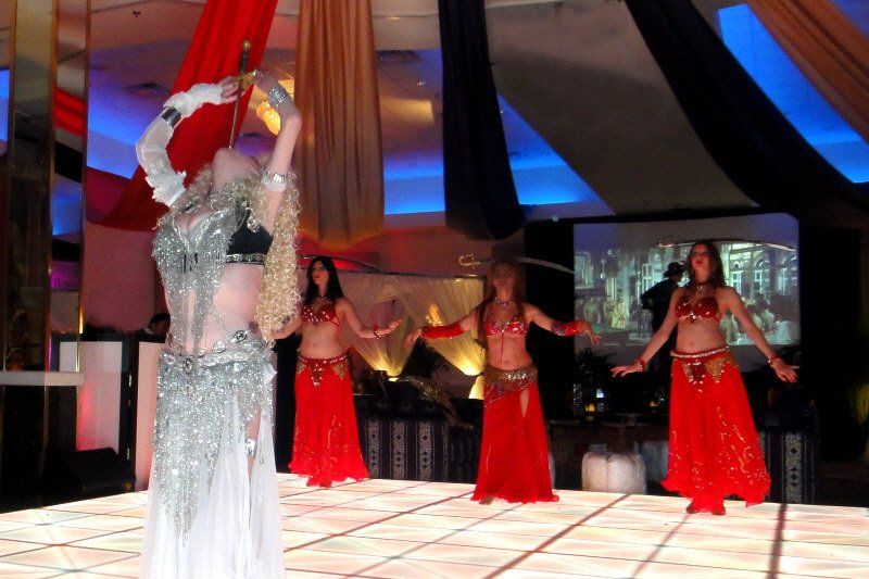 Specialty acts image showing group performing sword swallowing and sword dancing