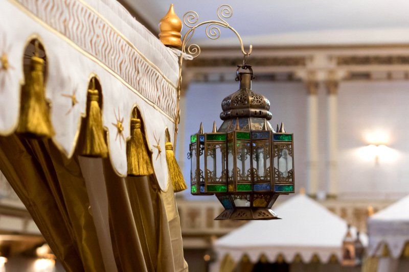Wedding celebration with Arabian styled tent and detail of hangin lamp