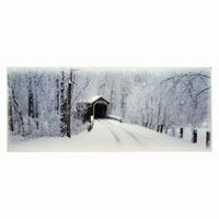 Snow-covered road leading to a covered bridge; trees line the sides, all dusted with snow, in a winter landscape.