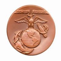 Bronze United States Marine Corps emblem with eagle atop globe, anchor, and scroll reading 
