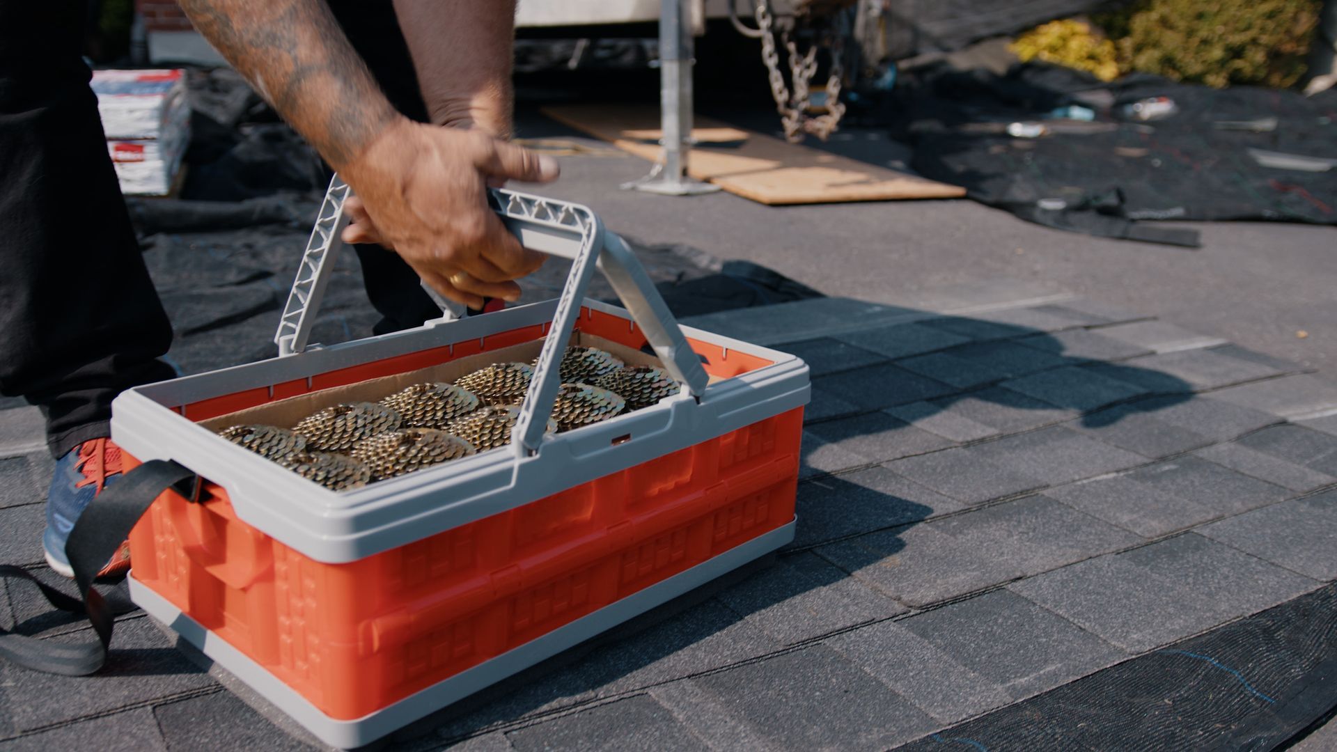 A person is laying a piece of concrete on a roof.
