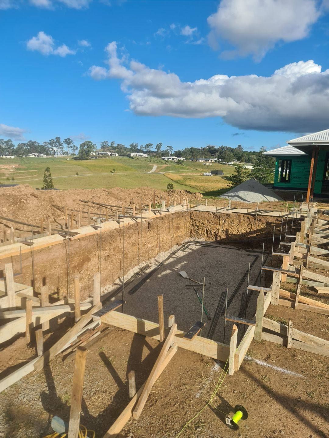 A pool is being built behind a house — CJB Pools in Gympie, QLD