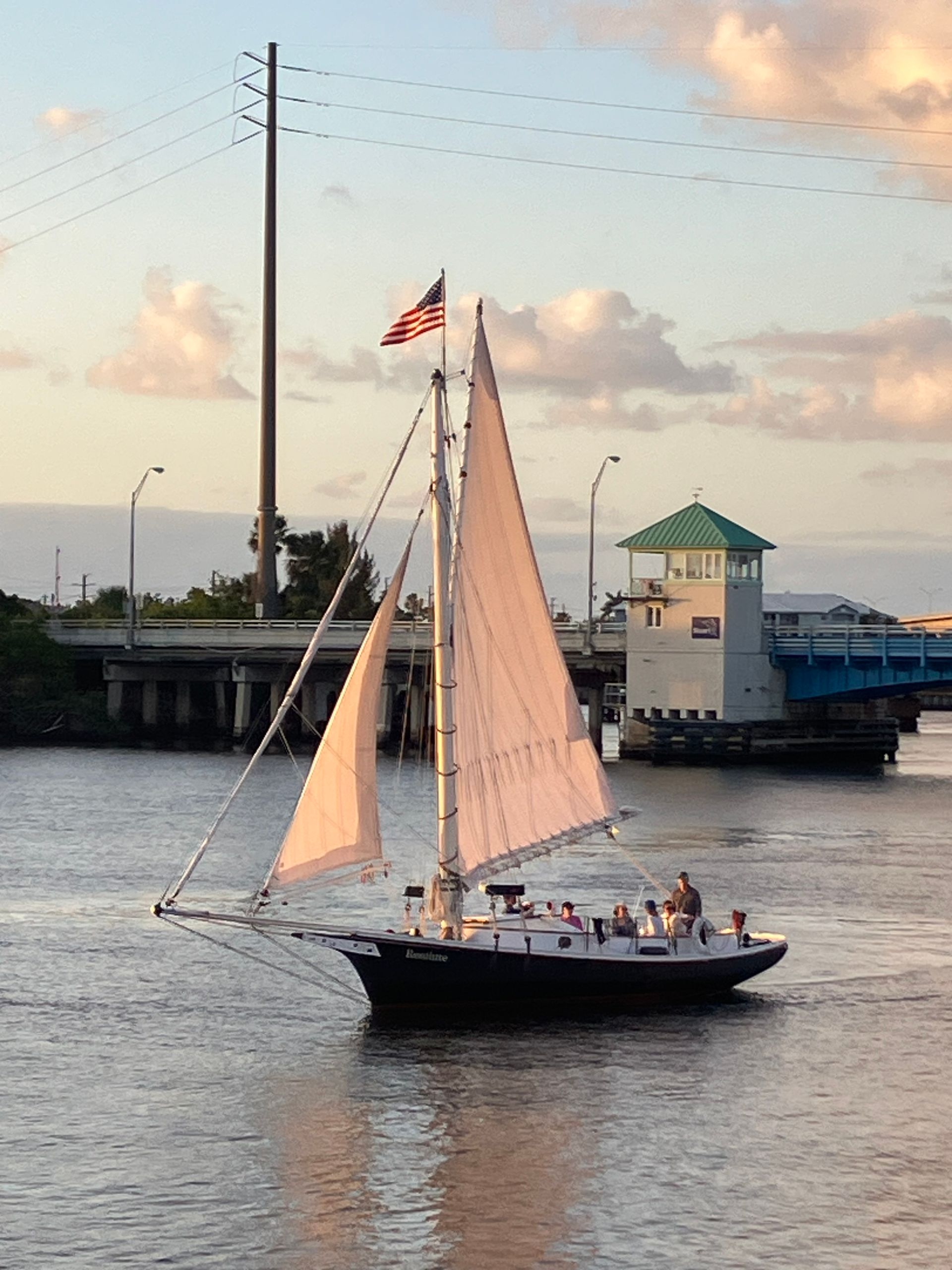 A sailboat with an american flag on top of it