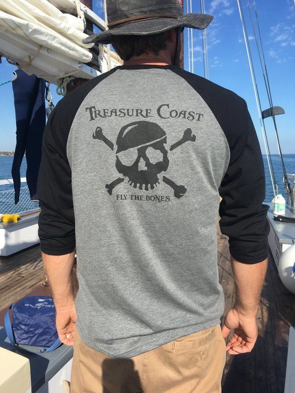 A man is wearing a treasure coast baseball shirt