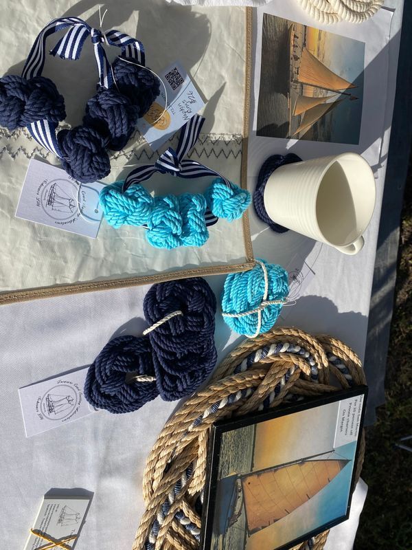 A table with yarn and a picture of a sailboat on it
