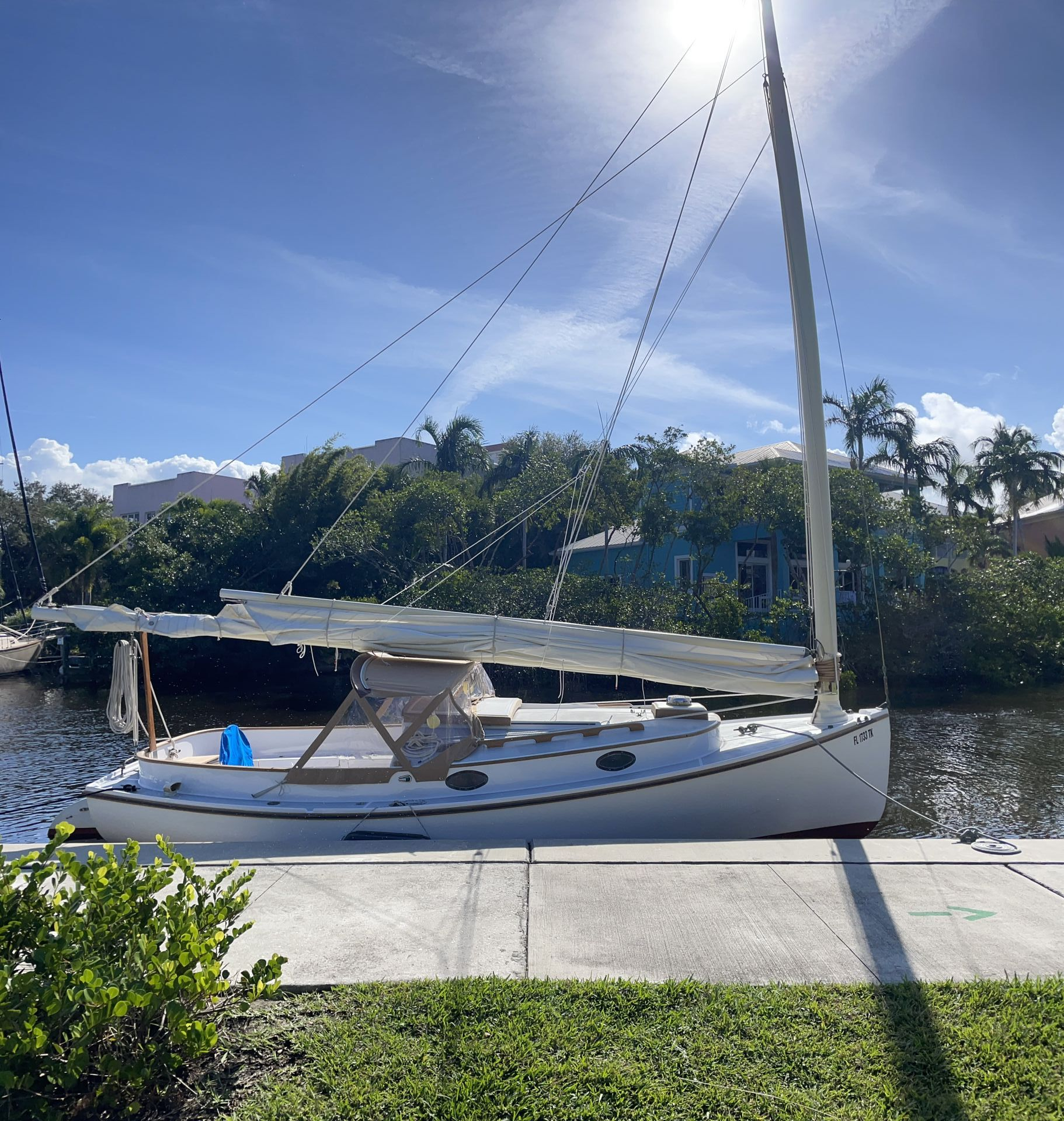 A sailboat is docked at a dock on a sunny day in Downtown Stuart at Treasure Coast Sailing Adventures