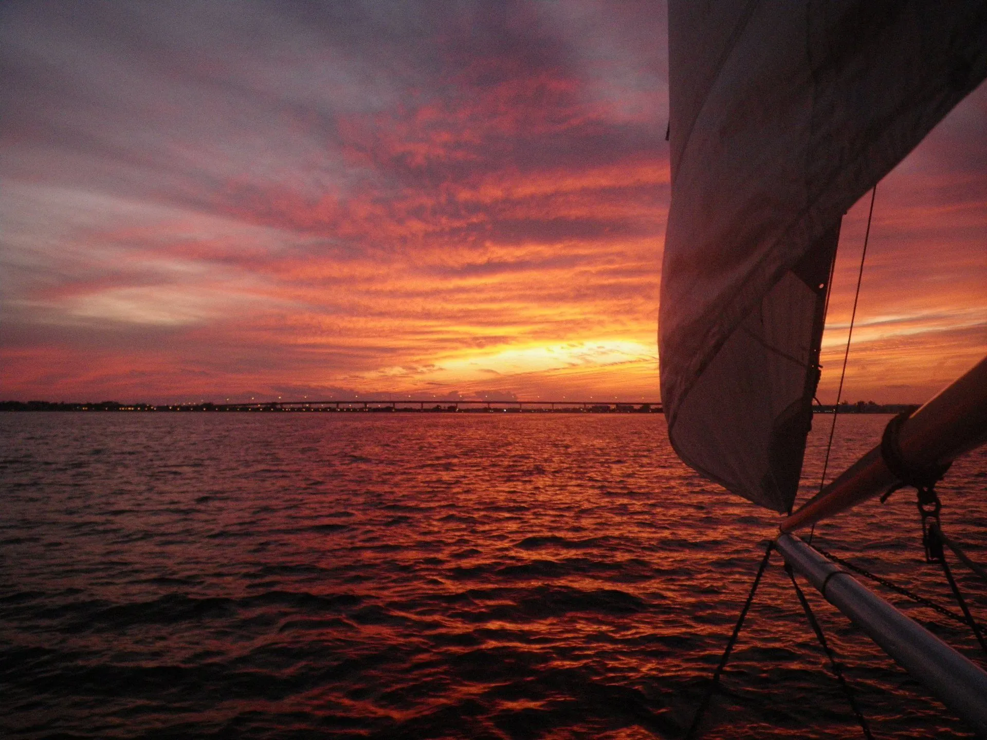 A sailboat with a stunning sunset in the background out of downtown Stuart Florida
