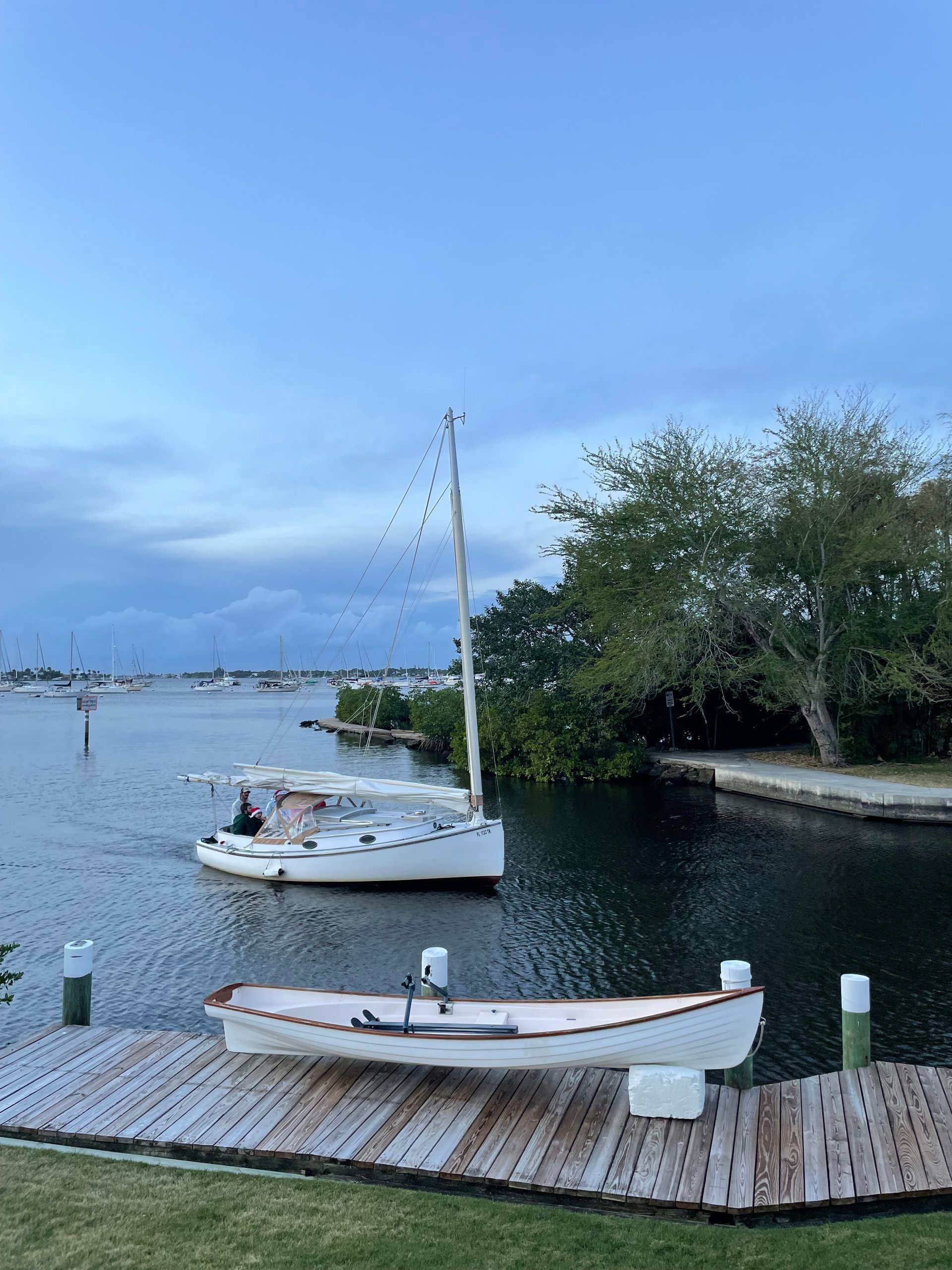 A boat is docked on a dock next to a body of water.