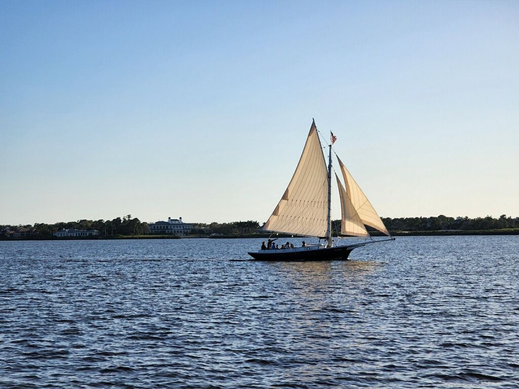 A sailboat is floating on top of a large body of water.
